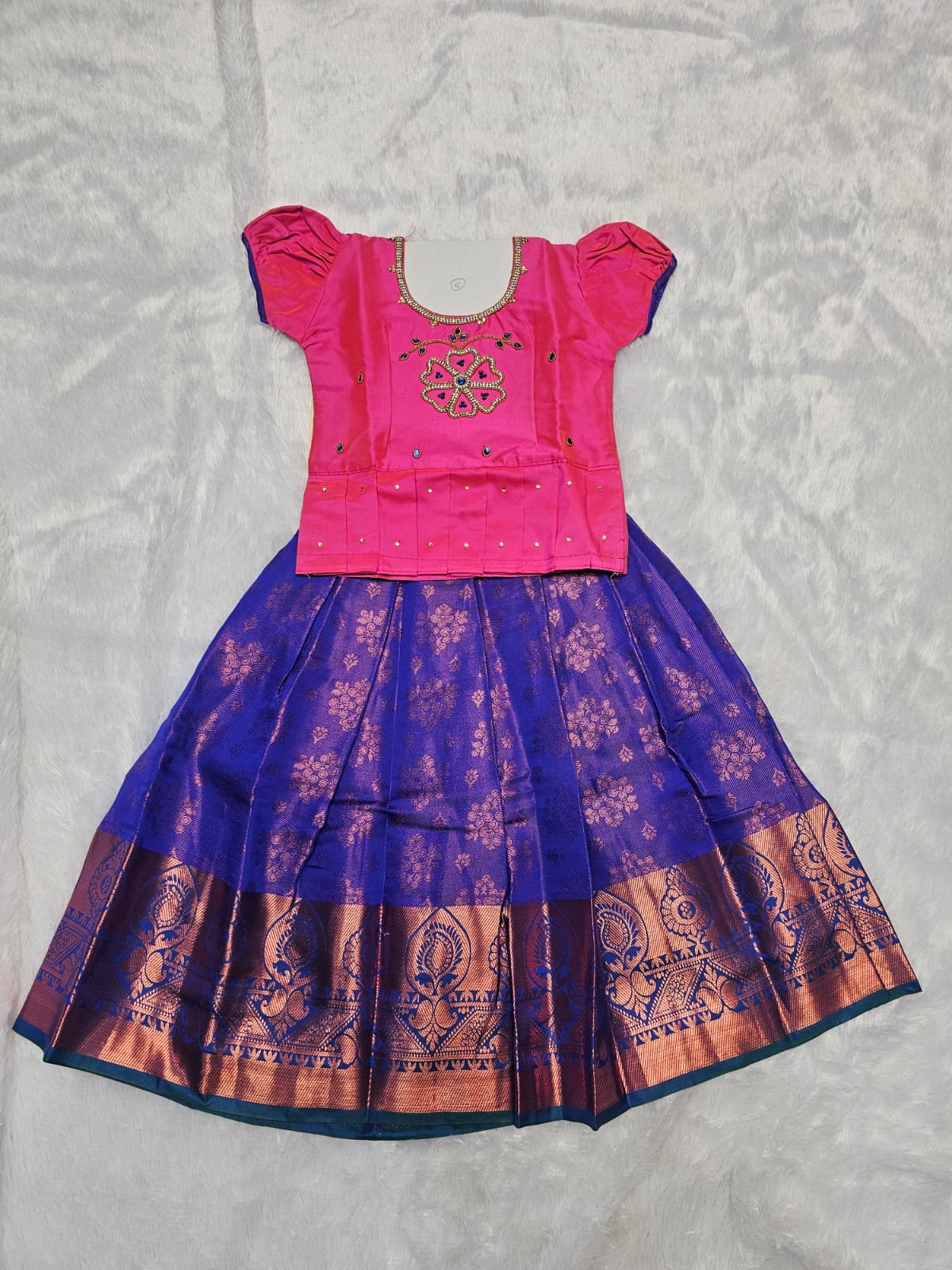 Pink semi silk top with royal blue bridal silk skirt pattu pavadai for girls featuring puff sleeves and double chain stone neck work, traditional South Indian ethnic wear by Sri Thulir Tex