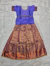 Royal violet semi silk top with copper gold bridal silk skirt pattu pavadai for girls featuring puff sleeves, waist belt design and double chain neck stone work by Sri Thulir Tex