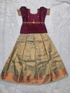 Wine maroon semi silk top with antique gold bridal silk skirt pattu pavadai for girls featuring puff hand sleeves, waist belt design and double chain neck stone work by Sri Thulir Tex