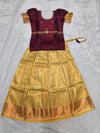 Wine maroon semi silk top with gold bridal silk skirt pattu pavadai for girls featuring puff sleeves, waist belt detailing and double chain stone neck work by Sri Thulir Tex