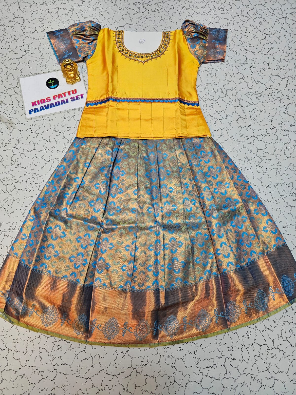 Yellow and blue kids pattu pavadai set with puff sleeves and zari bridal silk skirt by Sri Thulir Tex