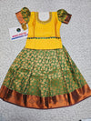 Yellow and green kids pattu pavadai set with puff sleeves and gold zari bridal silk skirt by Sri Thulir Tex