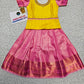 Yellow and pink kids pattu pavadai set with puff sleeves and bridal silk skirt by Sri Thulir Tex