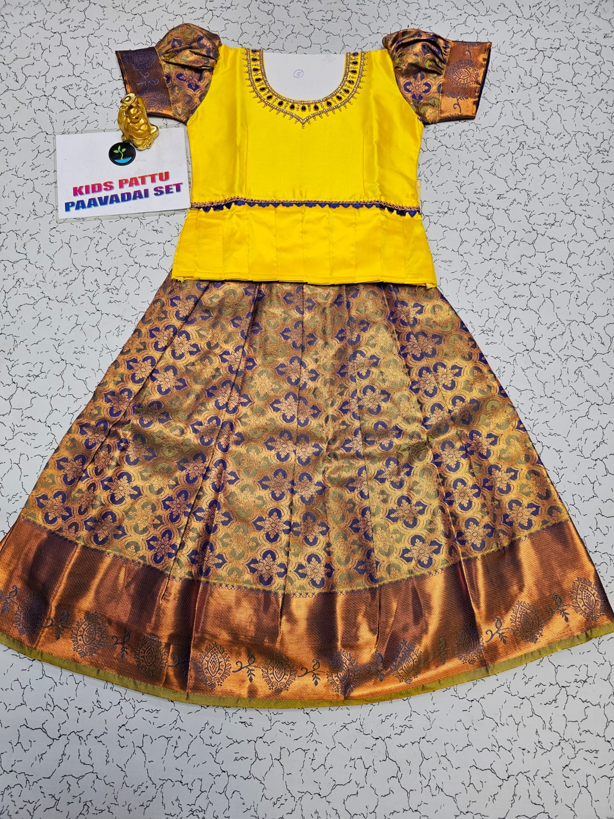 Yellow and purple kids pattu pavadai set with puff sleeves and bridal silk skirt by Sri Thulir Tex