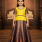 Yellow and purple kids pattu pavadai set with puff sleeves and bridal silk skirt by Sri Thulir Tex